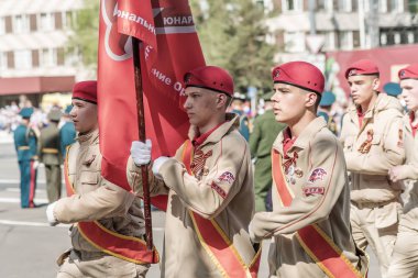 Banner group of Yunarmy in the parade. Orenburg, Russia - May 9, 2019: Victory Parade on Lenin Square clipart