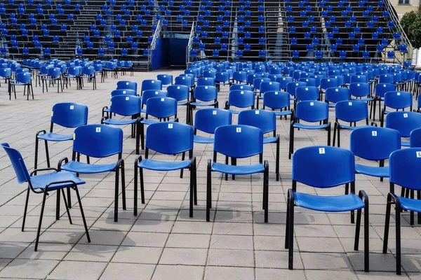 An uncrowded tribune at a mass event, with chairs arranged taking into account social distance. The picture was taken in the summer in Russia, in the city of Orenburg
