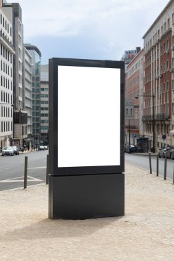 Blank vertical advertising billboard on a city street in Lisbon, Portugal, ready for mockup or commercial design