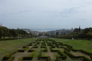 Lisbon, Portugal - Panoramic view from Eduardo VII Park overlooking the city, with the Tagus River in the background and the Marquis of Pombal Square visible on the right.