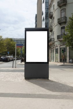 Blank vertical billboard at Saldanha, a central area of Lisbon, with surrounding buildings and urban traffic in the background.