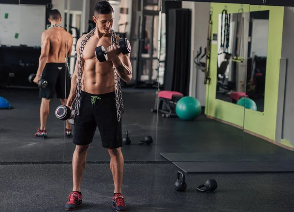 Giovane uomo muscoloso in palestra facendo esercizio — Foto Stock