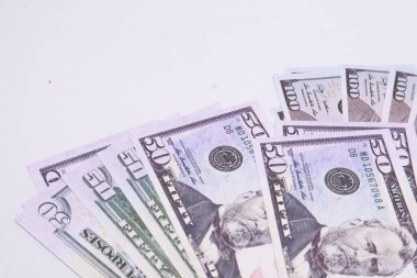 Beyaz bir arka planda, zenginliği ve finansal başarıyı simgeleyen 50 dolarlık banknotların yakın plan çekimi..