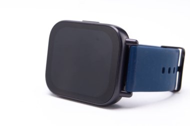 Beyaz arka planda izole edilmiş mavi bantlı siyah bir akıllı yamağın yakın çekimi. Odak noktası cihazların tasarımı ve giyilebilir teknoloji..