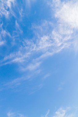 Beyaz tüylü bulutların üstünde yaz mavi gökyüzünde