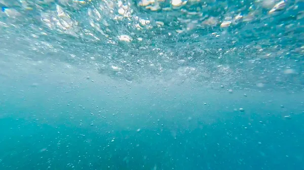 Photo under water from the pool water Park with bubbles