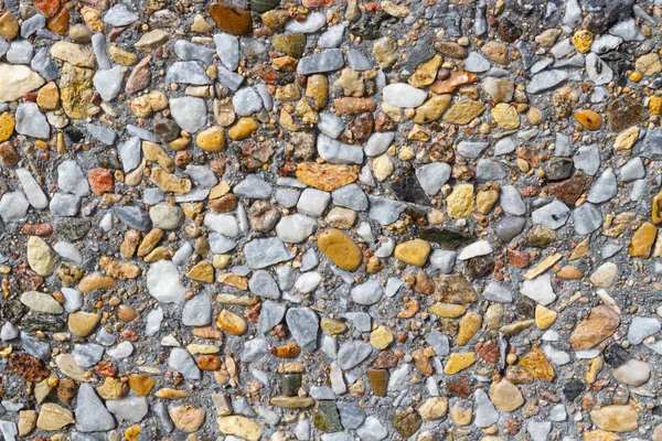 Wall of small colored stone made of cement
