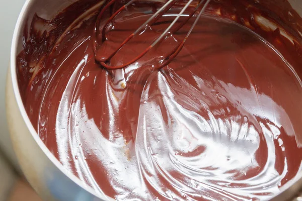 Thorough mixing of the liquid chocolate for dessert cooking — Stock Photo, Image