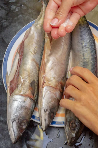 Marinating raw fish mackerel for baking on the grill