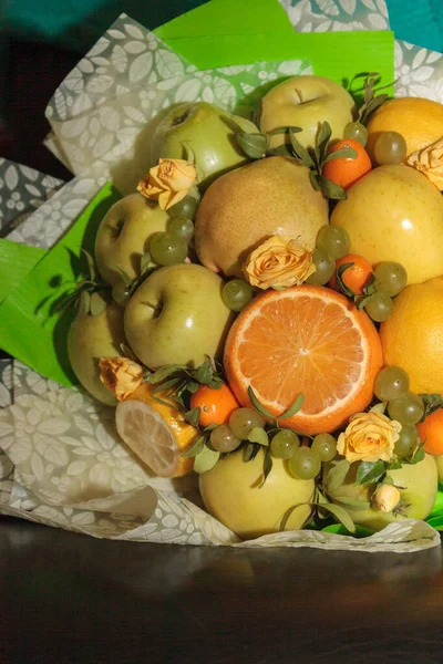 Fruit and floral green bouquet with apples and citrus