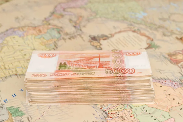 A large wad of Russian money is on the map of the world