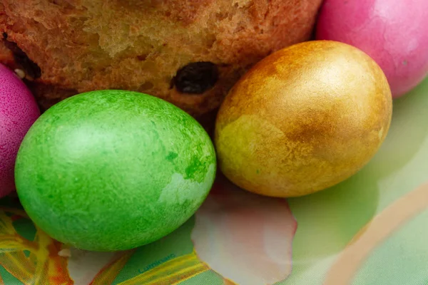 Easter cake and Easter bright colored eggs are on the plate