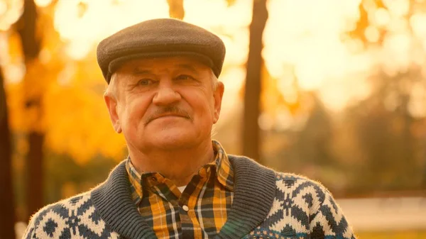 Old man portrait in the autumn park — Stock Photo, Image