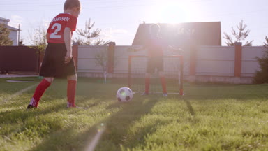 Küçük çocuklar arka bahçe'nın bahçesinde futbol oynayan