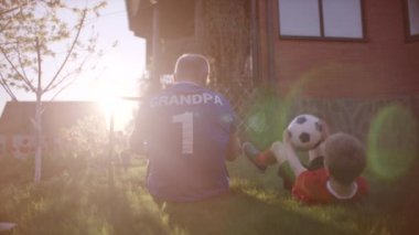 Dede ve torunu'nın bahçesinde futbol topu Sunset'teki ile BACKSHOT