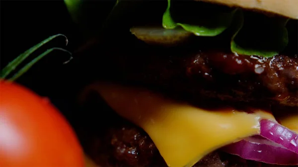 Close up of burger bun with sesame, greens, cheese and beef for commercial use — Stock Photo, Image