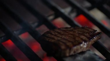 Biftek yakın yangın alevler ile ızgara, Şef onları ağır çekim bitti, döner