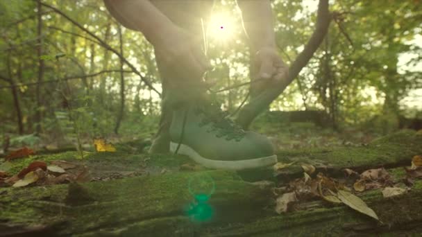 Close up de cadarços de gravata em botas de trekking durante a caminhada no pôr do sol — Vídeo de Stock