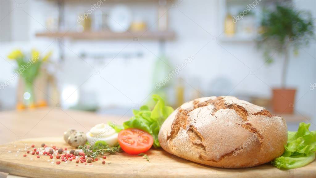 Commercial packshot with home baked bread and fresh greens at the table