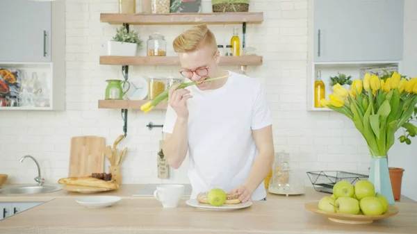 Hermoso hombre rubio está haciendo el desayuno para su novia en la mañana Imágenes De Stock Sin Royalties Gratis