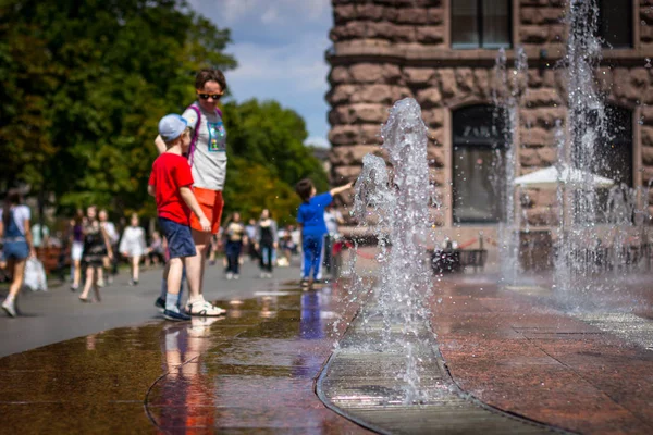 Moeder neemt foto's van haar zoon bij de fontein — Stockfoto