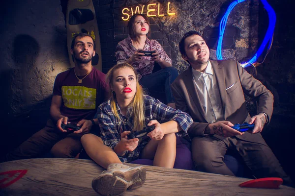 Guys and girls play computer games with joysticks in hand — Stock Photo, Image