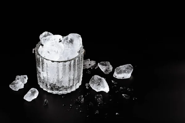 crystal bucket with ice on a dark background