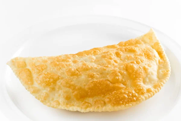 Crispy deep fried turnover with meat on a white background. Cheburek , crimean tatars cuisine close up — Stock Photo, Image