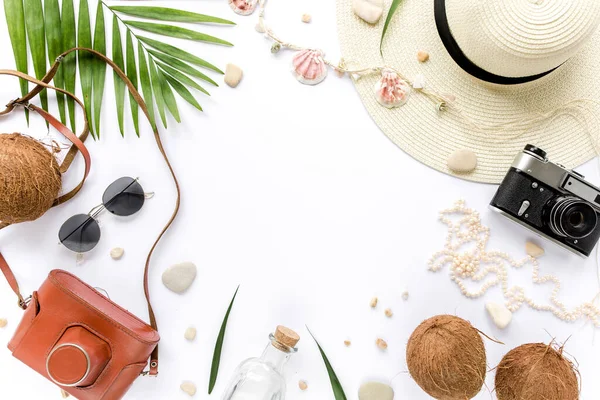 Weibliche beige Badeanzug-Strandaccessoires, tropische Palmblätterzweige, Kokosnüsse auf weißem Hintergrund. Sommer im Hintergrund. Straßenrahmen gesetzt. — Stockfoto