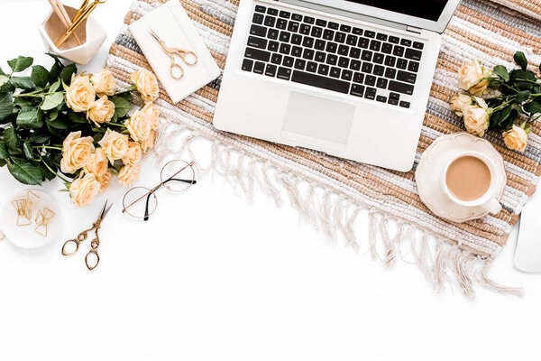 Female workspace with laptop, roses flowers, golden accessories, diary, computer, glasses on white background. Flat lay womens office desk. Top view