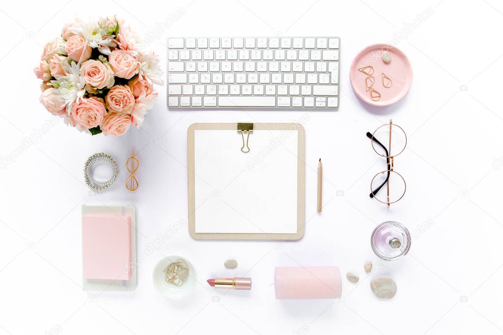 Stylized womens desk, office desk. Workspace with, laptop, roses, clipboard. Womens fashion accessories on white background. Flat lay Top view