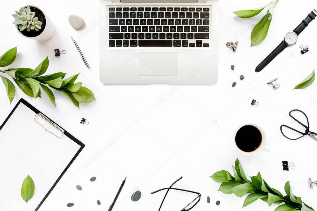 Office desk. Workspace frame with paper blank, green leaves. Laptop, glasses on white background. Magazines, websites, media. Flat lay, top view