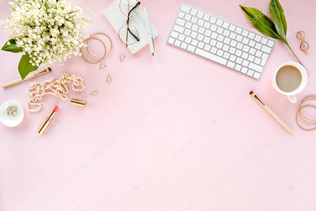Office table desk with computer, lilac, clipboard. magazines. Top view Flat lay. Home office workspace. Womens fashion accessories on pink background