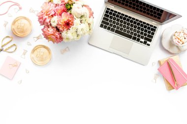 Tarz sahibi kadınların ofis masası. Laptop, bilgisayar, buket ranunculus ve güllerle çalışma alanı, beyaz arka planda pano. Düz yatıyordu. Üst görünüm.