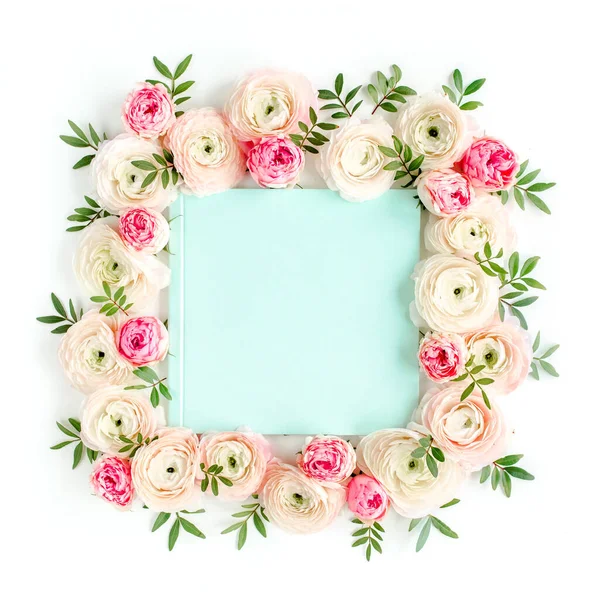 Floral pattern frame made of pink ranunculus and roses flower buds on white background. Flat lay, top view floral background.
