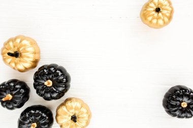 Şık Cadılar Bayramı süslemeleri. Dekoratif balkabağı siyah ve altın cadılar bayramı beyaz arka planda izole. Düz yatış, üst görünüm.