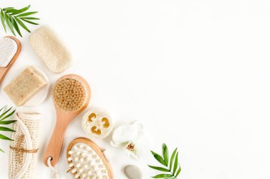 Spa arka planı. Doğal Organik Spa kozmetik ürünleri, çevre dostu banyo aksesuarları, palmiye yaprakları. Beyaz arka planda cilt konsepti. Düz yatıyordu