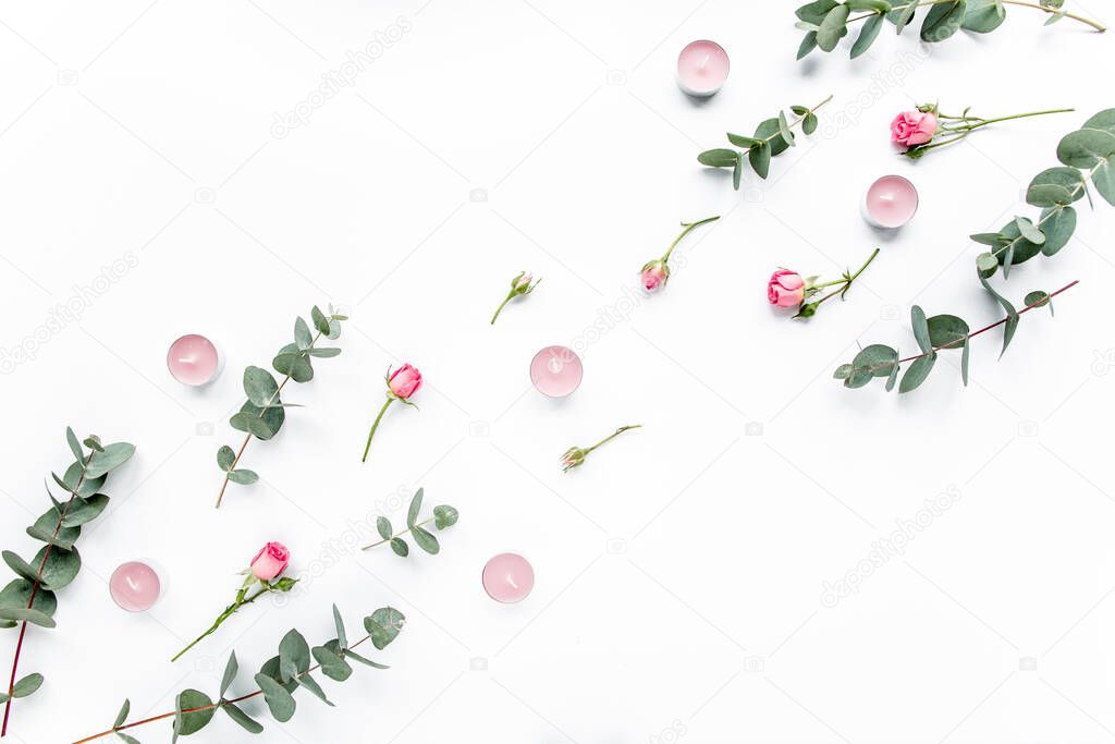 Floral pattern made of pink roses, green leaves eucalyptus, branches on white background. Flat lay, top view. Valentines background. Floral pattern.