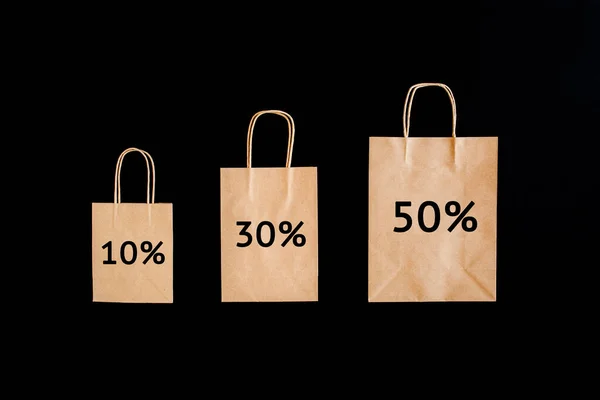 Black Friday sales discount concept. Craft paper bags with word Sale on black background. — Stock Photo, Image