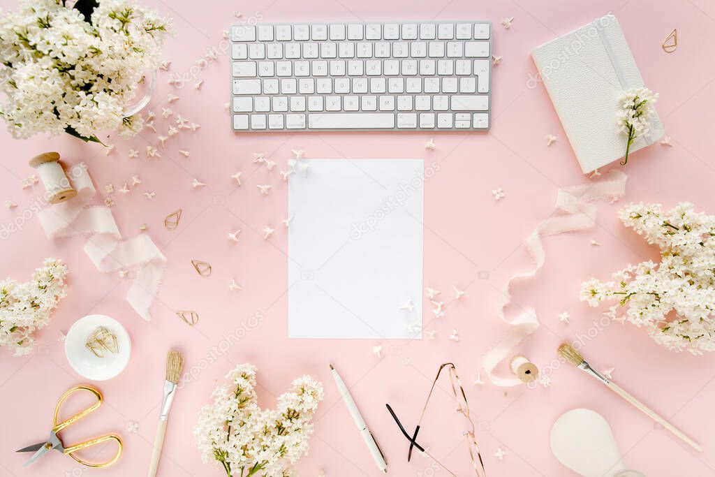 Office table desk with computer, lilac, clipboard. magazines. Top view Flat lay. Home office workspace. Womens fashion accessories on pink background