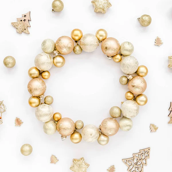Holiday round frame, pattern made and gold glass Christmas balls, golden toys isolated on a white background. Merry Christmas. Flat lay, top view
