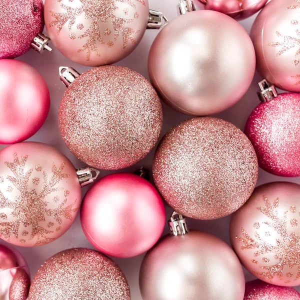Christmas texture: pink glass christmas balls on white background. flat lay, top view