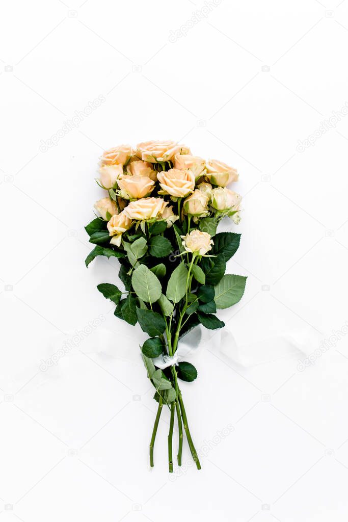 Pastel tea rose bouquet flowers on white background. Floral background. Minimal floral concept. Flat lay, top view. 