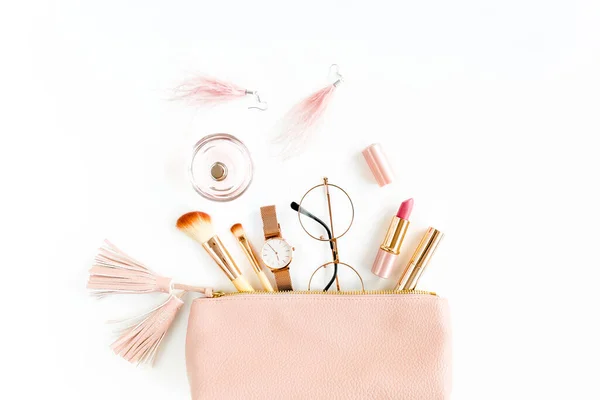 Flat lay composition with pink cosmetic bag with cosmetic makeup products, isolated on white background. Flat lay, top view.