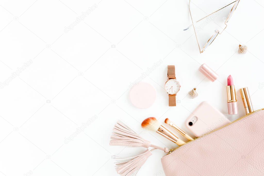 Flat lay composition with pink cosmetic bag with cosmetic makeup products, isolated on white background. Flat lay, top view.