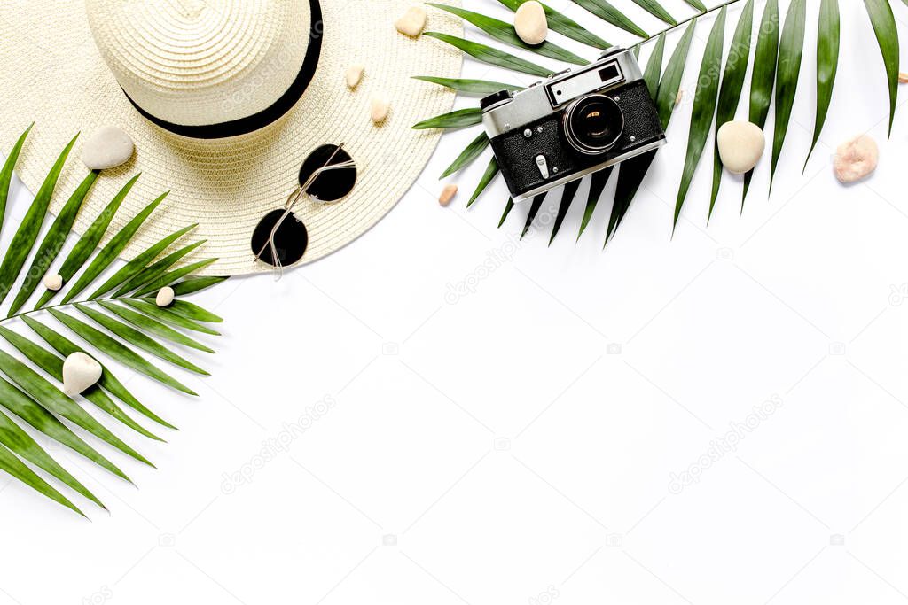 Traveler accessories, tropical palm leaf branches on white background with empty space for text. Travel vacation concept. Summer background. 