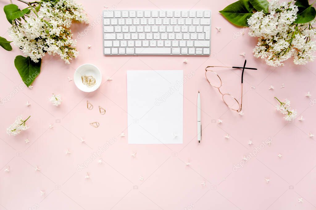 Office table desk with computer, lilac, clipboard. magazines. Top view Flat lay. Home office workspace. Womens fashion accessories on pink background