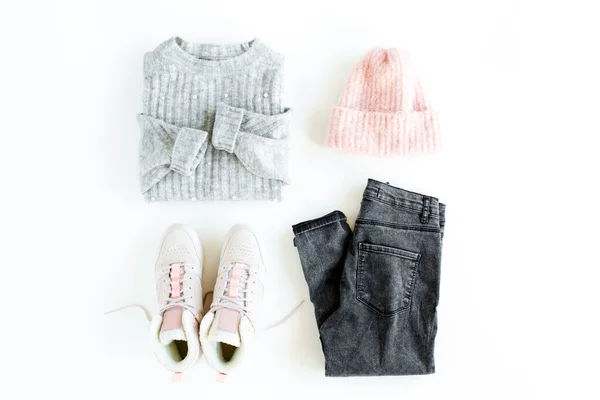 Women fashion clothes and accessories. Feminine youth collage, top view. Flat lay female style look with warm sweater, jeans, cap, sneakers. Top view. — Stock Photo, Image