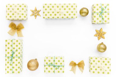 Noel ya da yeni yıl kompozisyonu. Beyaz arka planda Noel altın madalyalarından yapılmış bir çerçeve. Üst Manzara. Düz yatıyordu