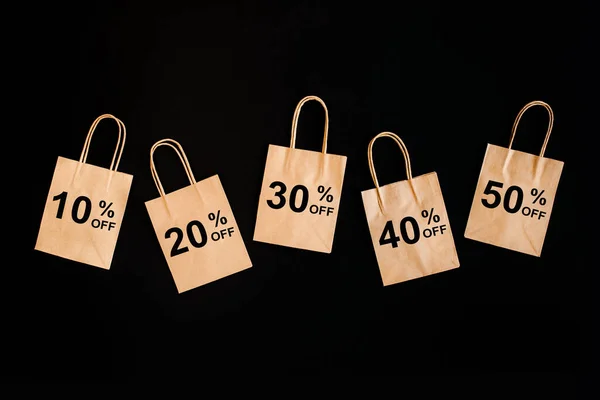 Black Friday sales discount concept. Craft paper bags with word Sale on black background. — Stock Photo, Image